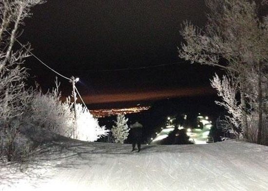 trails lit up at night for skiing and boarding